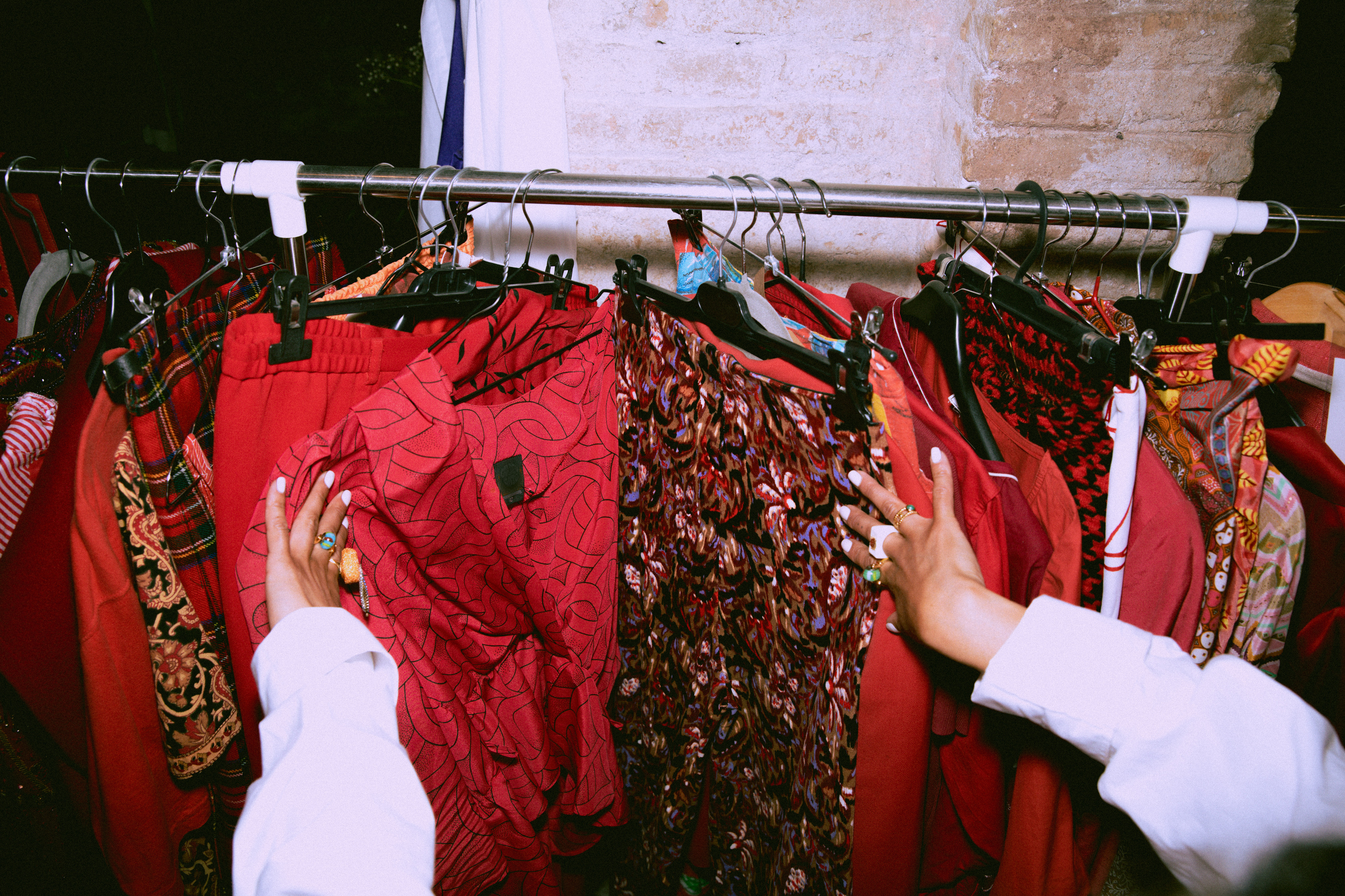 Woman Selecting Vintage Clothes in a Thrift Shop
